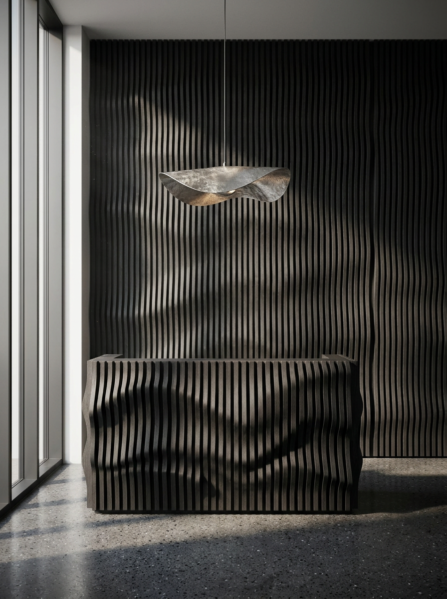 Blackened oak reception desk against a full-height wave wall