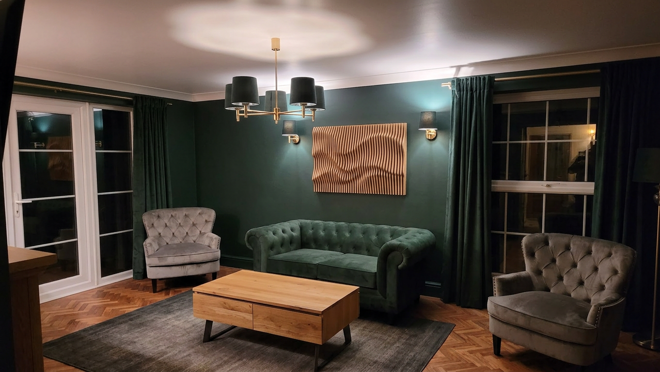 Oak wave panel on a deep-green wall above a velvet sofa, lit by lamplight